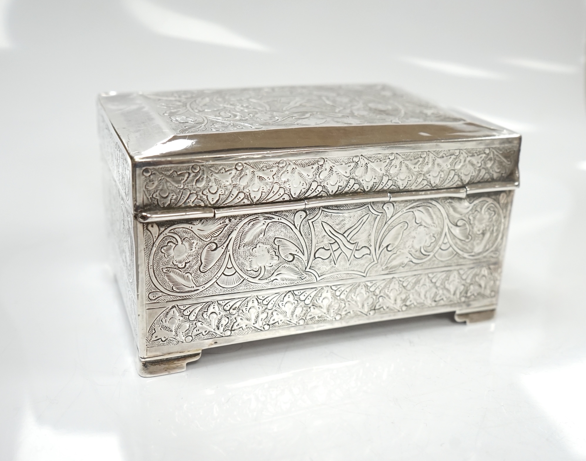 Two silver cigarette cases, a silver plated cigarette case and a Thai? white metal cigarette box, 11.6cm. Condition - poor to fair